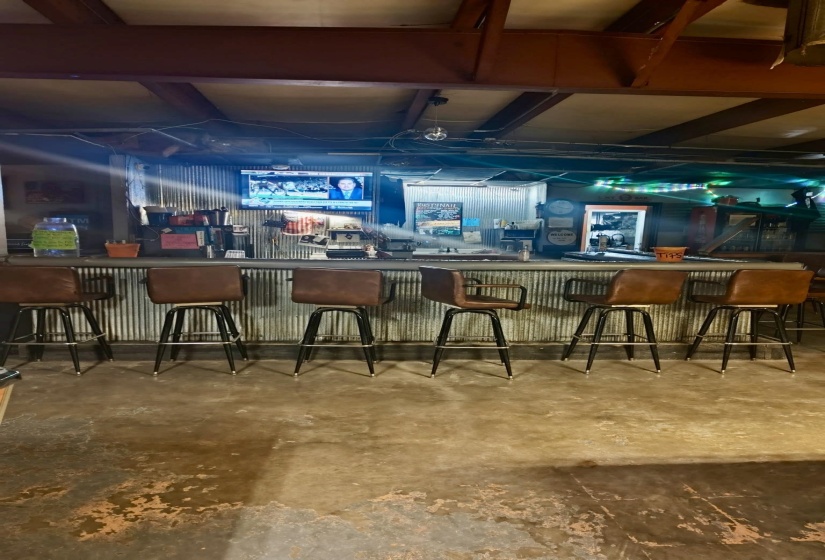 Bar featuring a bar and concrete flooring