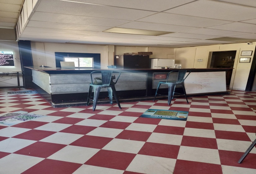 Bar with a drop ceiling and tile patterned floors