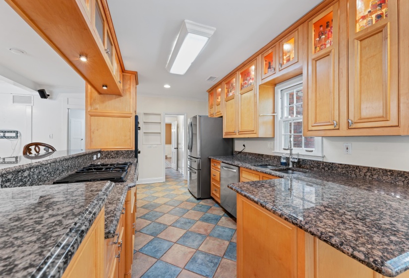 Kitchen featuring custom maple cabinets, stainless steel appliances, and granite counters