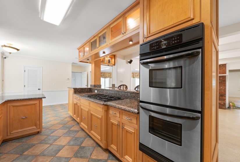 Kitchen featuring granite countertops, gas cooktop and double oven