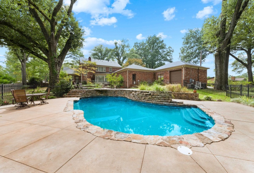 Ramp to rear garage for riding lawn mower can be seen in background.