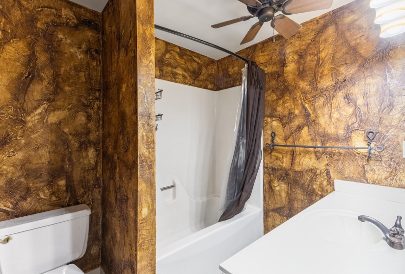 Full bath featuring shower / tub combo and ceiling fan