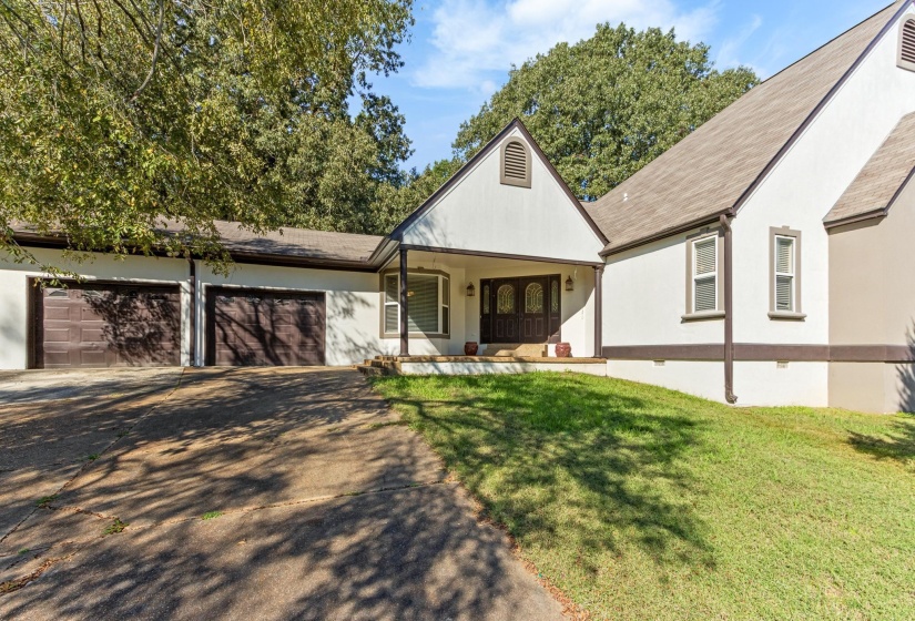 View of front facade featuring crawl space, driveway, a front yard, covered porch, and a garage