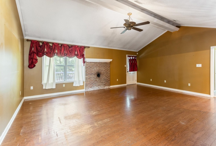 Unfurnished living room featuring a ceiling fan and light wood-style floors