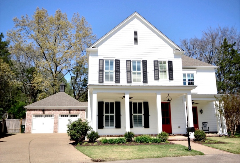 View of front of home featuring concrete driveway, roof with shingles, covered porch, and a ceiling fan