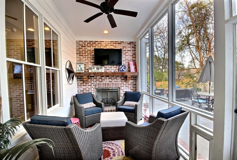 Sunroom featuring ceiling fan and an outdoor living space with a fireplace