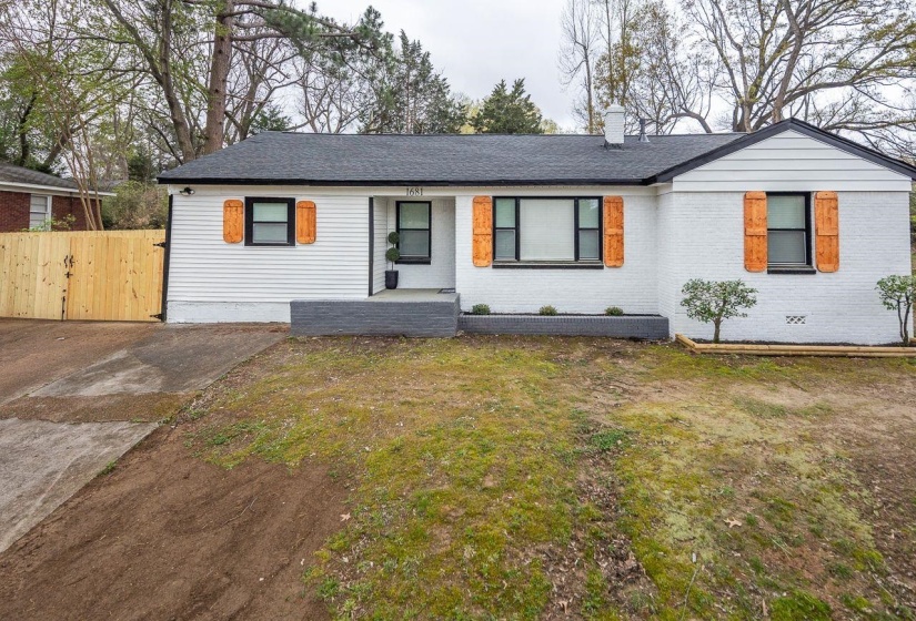 Single story home with fence, a front lawn, brick siding, a shingled roof, and a chimney