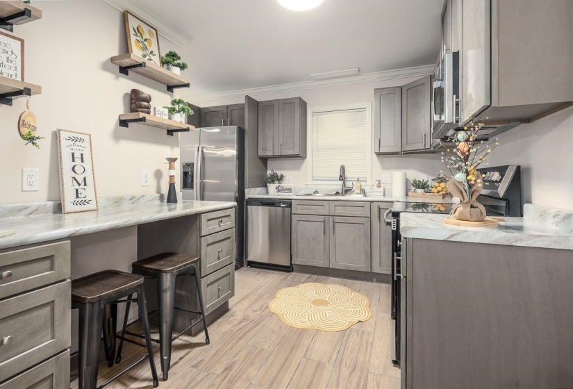 Kitchen with gray cabinetry, a sink, appliances with stainless steel finishes, and open shelves