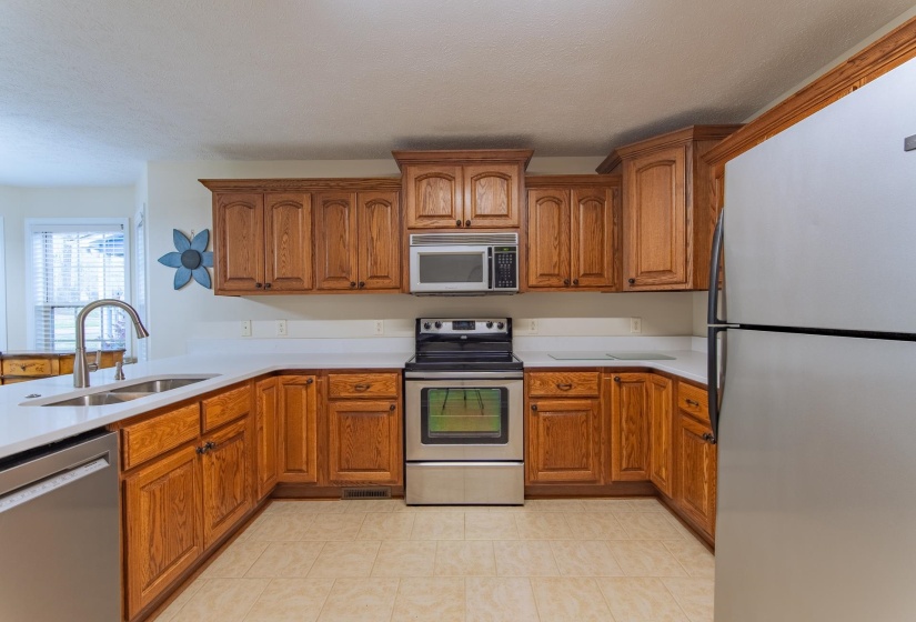 Kitchen featuring a sink, brown cabinets, and appliances with stainless steel finishes
