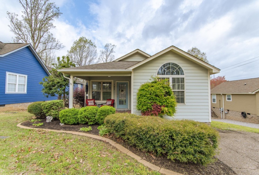 View of front facade featuring covered porch and a shingled roof