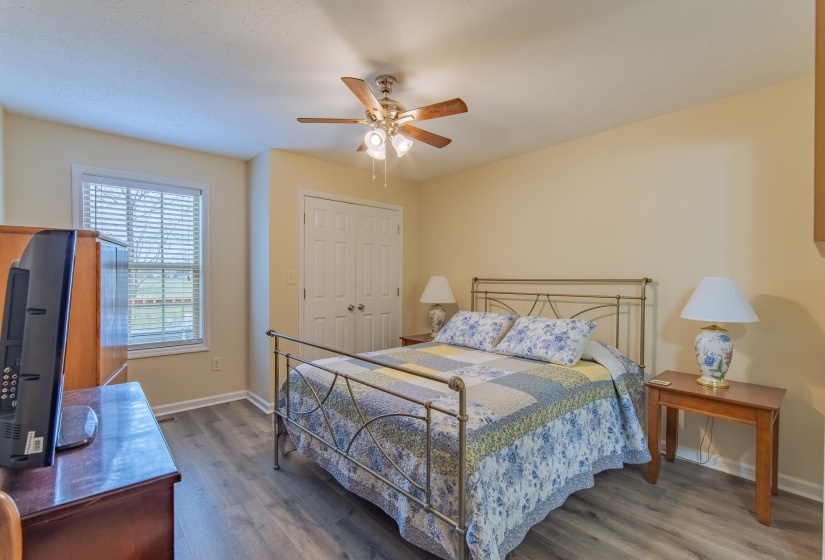 Bedroom with baseboards, ceiling fan, and wood finished floors