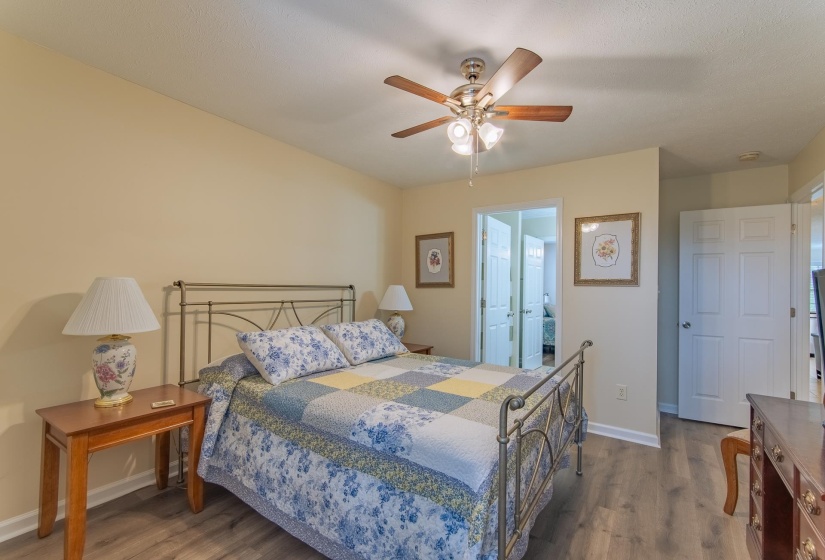 Bedroom featuring baseboards, ceiling fan, and wood finished floors