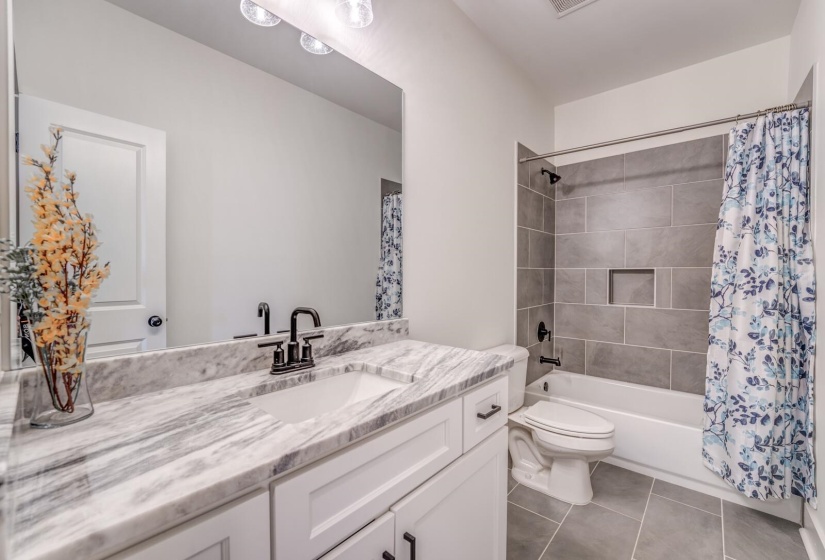 Full bath with vanity, toilet, tile patterned floors, visible vents, and shower / bath combination with curtain