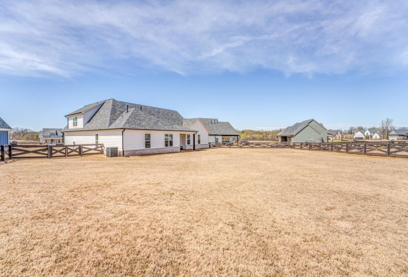 View of yard featuring a fenced backyard and central AC