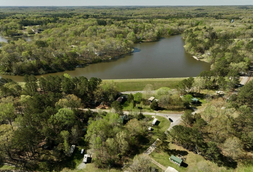 Drone / aerial view featuring a wooded view and a water view