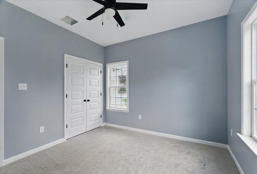 Unfurnished bedroom featuring carpet floors, baseboards, and a closet
