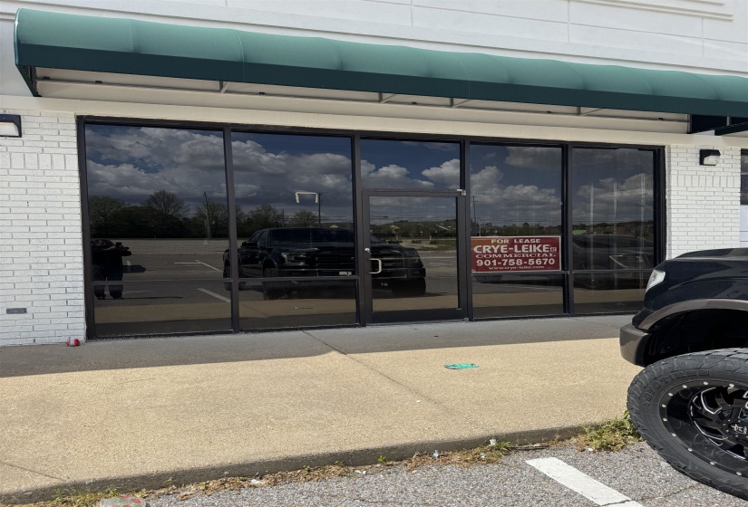 Property entrance featuring brick siding