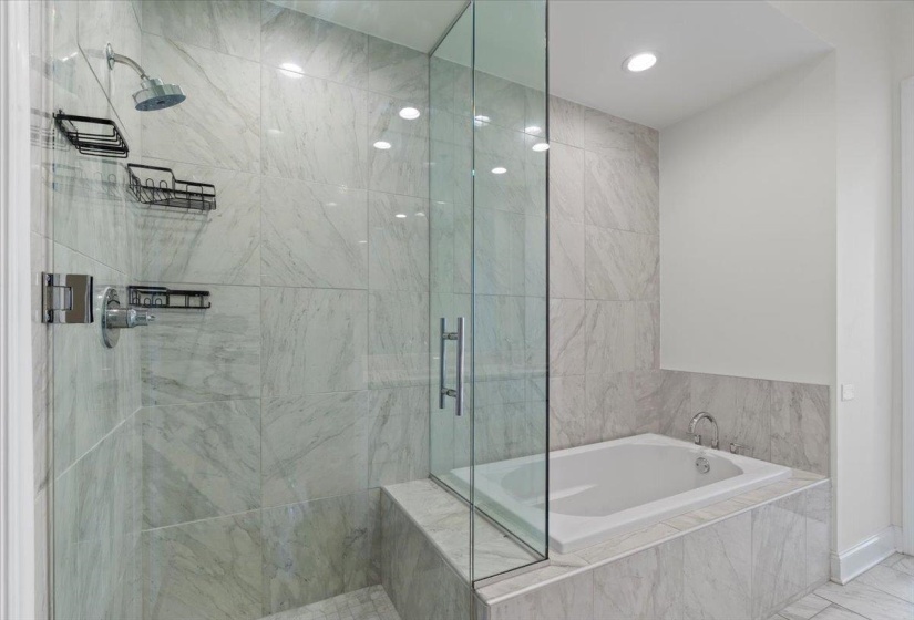 Bathroom with a shower stall and a garden tub