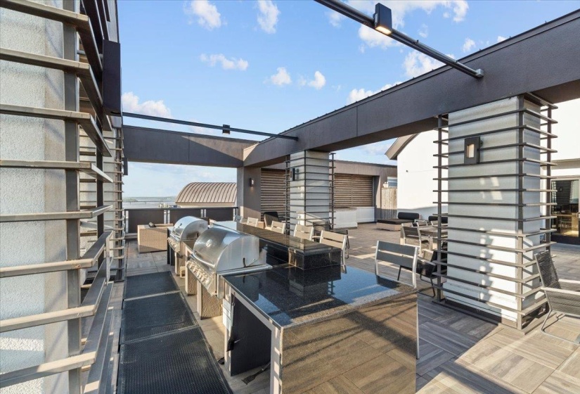View of patio with area for grilling and exterior kitchen
