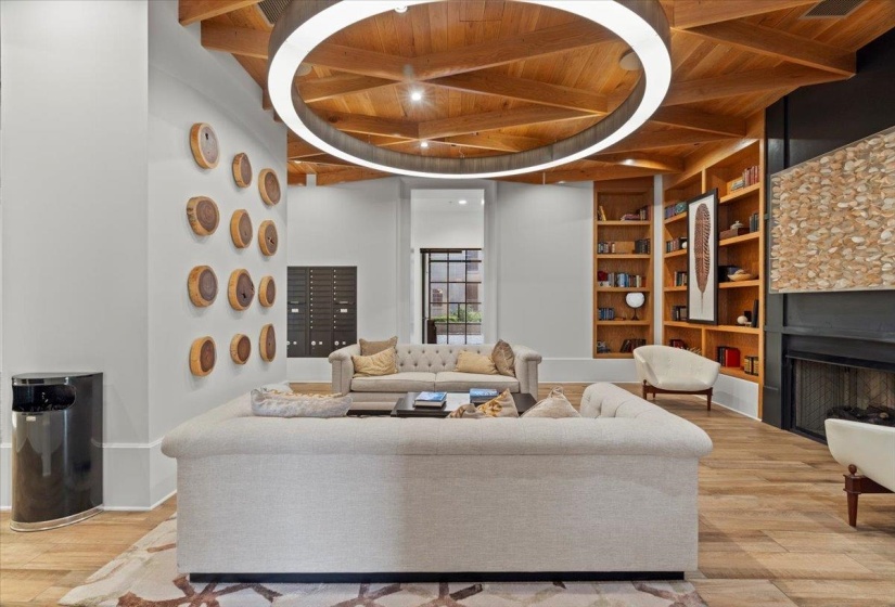 Living area featuring beamed ceiling, built in shelves, wooden ceiling, and wood finished floors