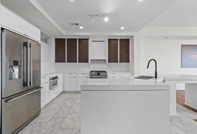 Kitchen with appliances with stainless steel finishes, marble finish floor, modern cabinets, and visible vents