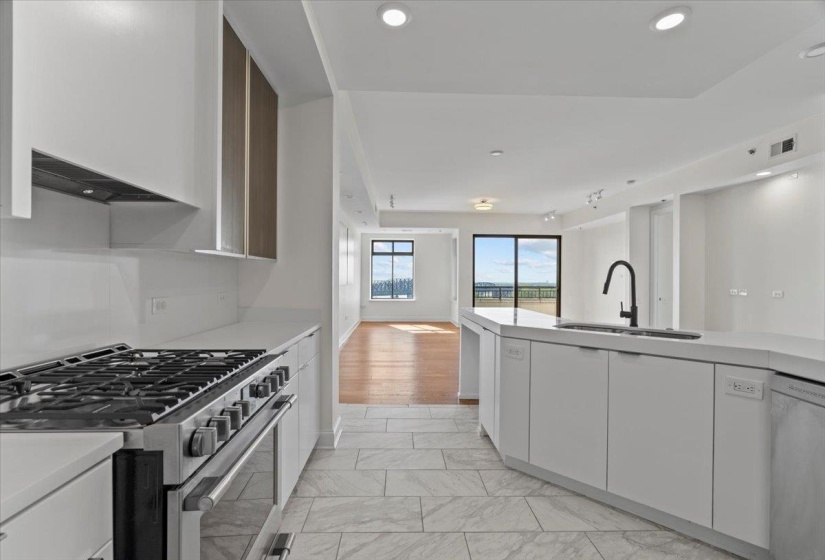 Kitchen featuring light countertops, appliances with stainless steel finishes, and a sink