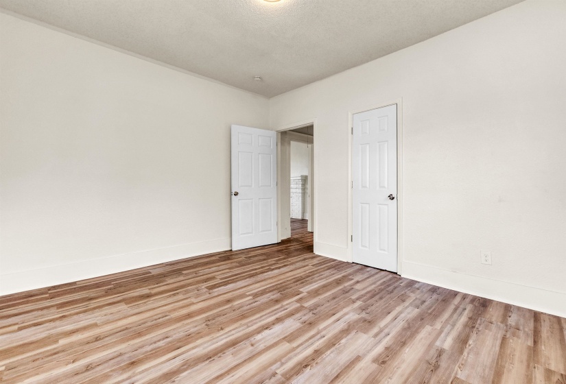 Unfurnished room featuring light wood-type flooring and baseboards