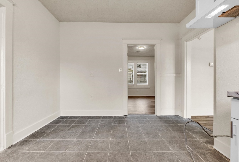 Empty room with baseboards and tile patterned flooring