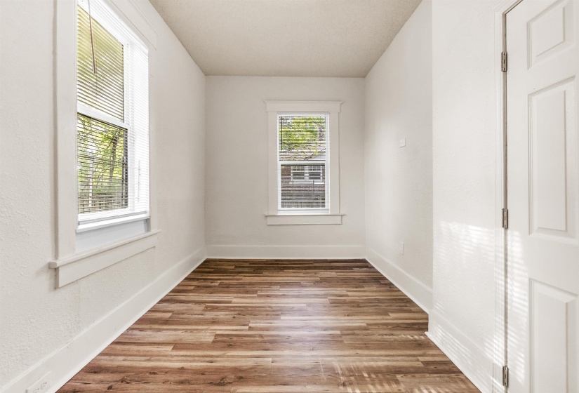 Empty room featuring baseboards and wood finished floors