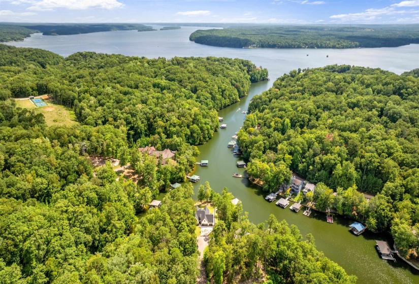 Aerial view of a heavily wooded area and a nearby body of water