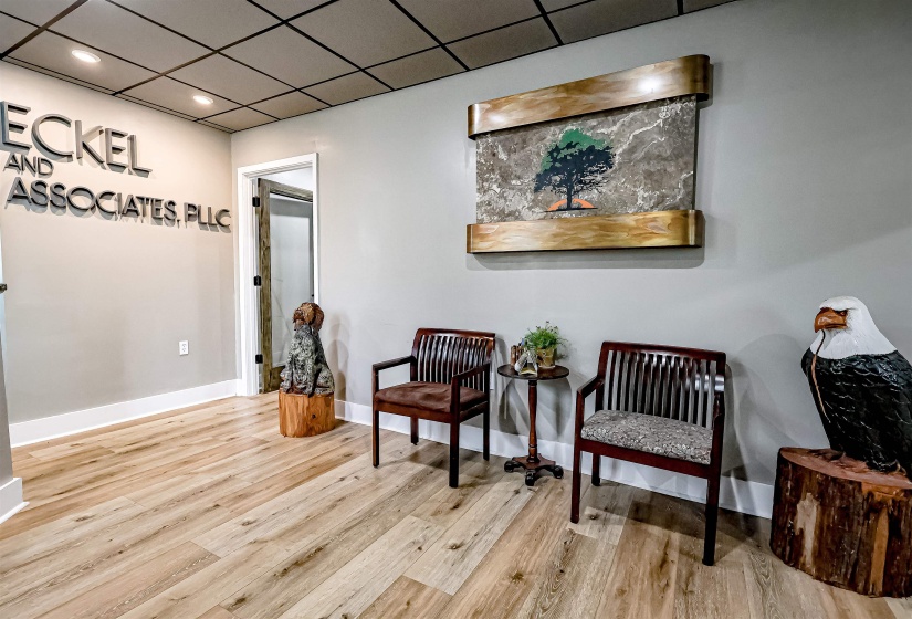 Living area featuring baseboards, wood finished floors, and recessed lighting