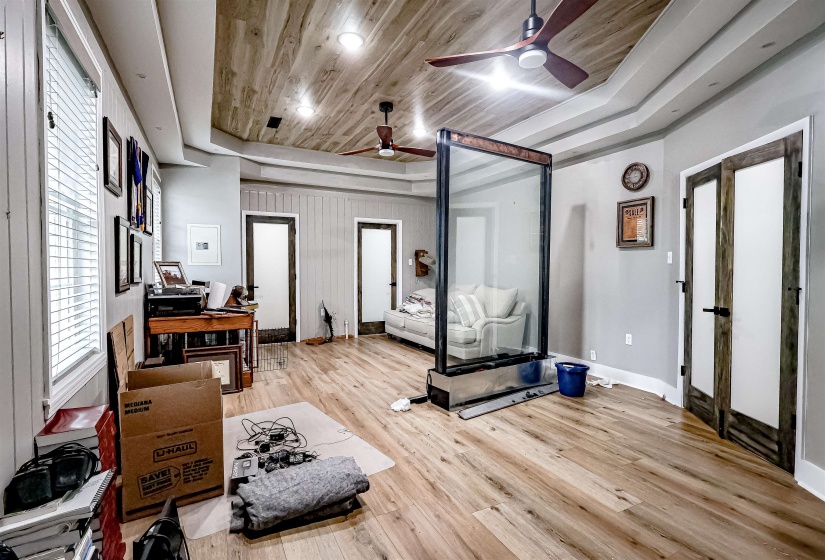 Exercise room featuring ceiling fan, wooden ceiling, wood finished floors, and baseboards