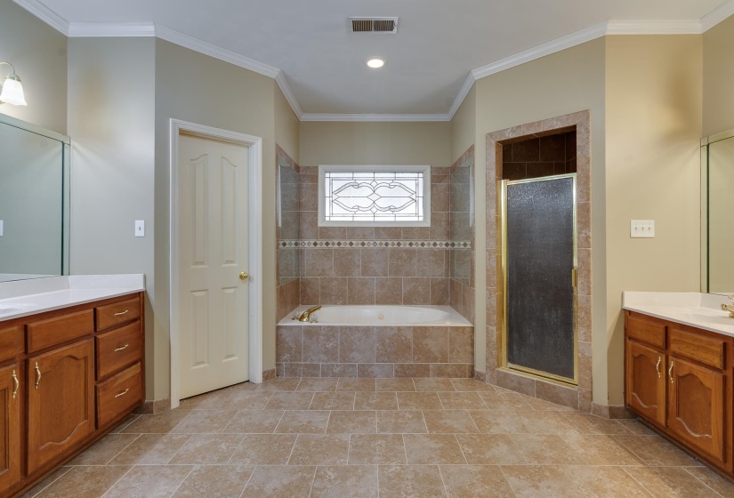 Full bathroom featuring vanity, a bath, ornamental molding, a stall shower, and recessed lighting