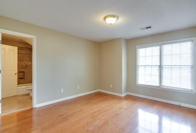 Bedroom featuring a textured ceiling and light wood-style flooring