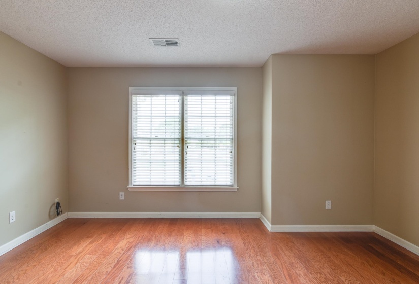 Empty room featuring a textured ceiling and light wood-type flooring