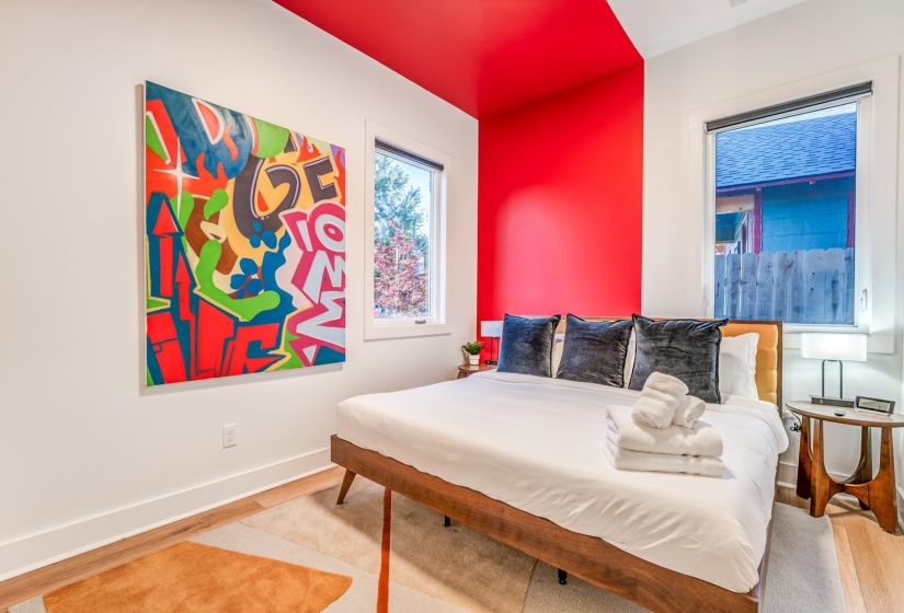 Bedroom featuring wood finished floors and baseboards