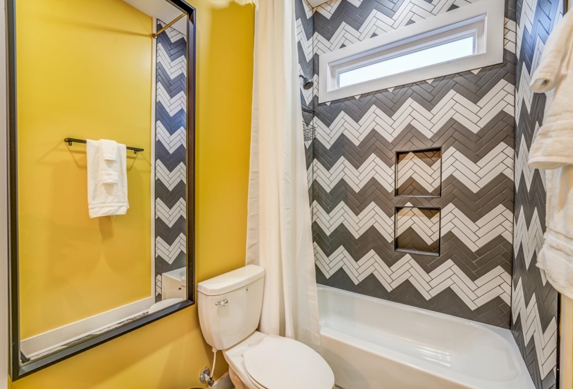 Full bath featuring shower / bath combo with shower curtain and toilet