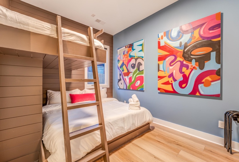 Bedroom featuring wood finished floors, visible vents, and baseboards