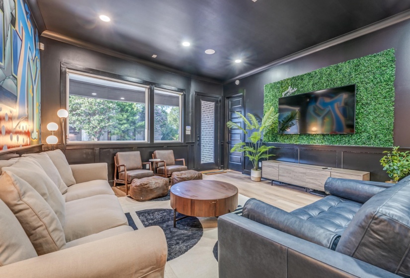 Cinema with a decorative wall, ornamental molding, and recessed lighting