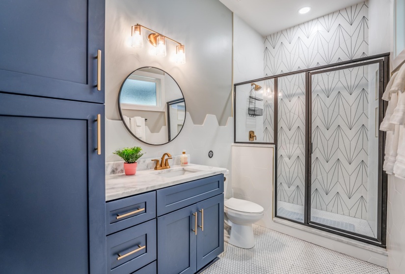 Full bath featuring a shower stall, toilet, vanity, and tile patterned floors