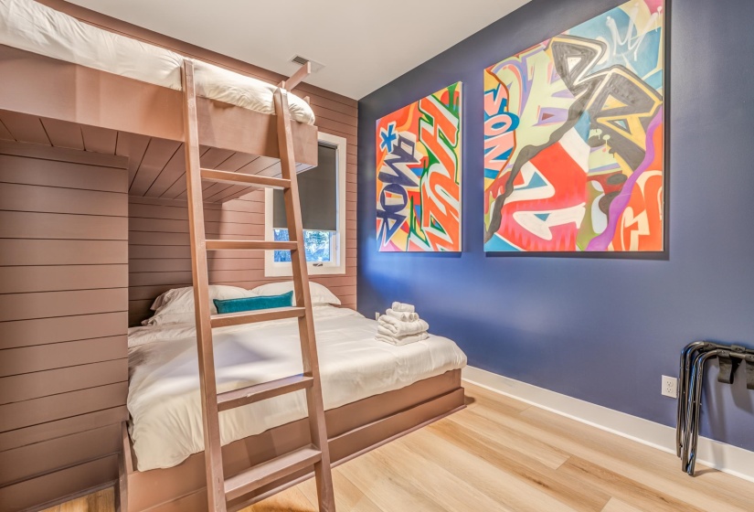Bedroom with baseboards, wood finished floors, and visible vents