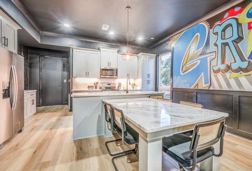 Dining space with light wood finished floors and recessed lighting