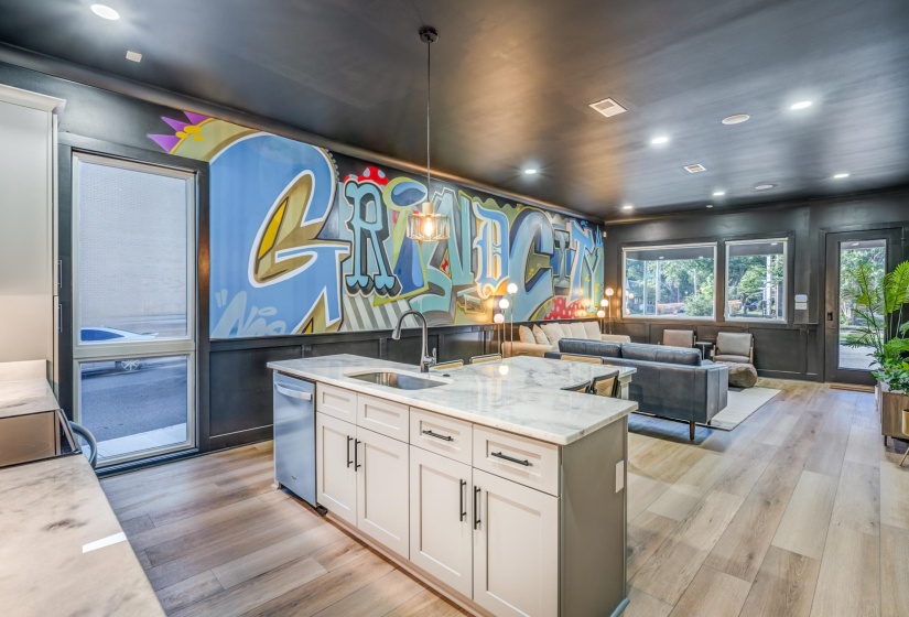 Kitchen featuring visible vents, a sink, light wood-type flooring, light stone countertops, and white cabinetry