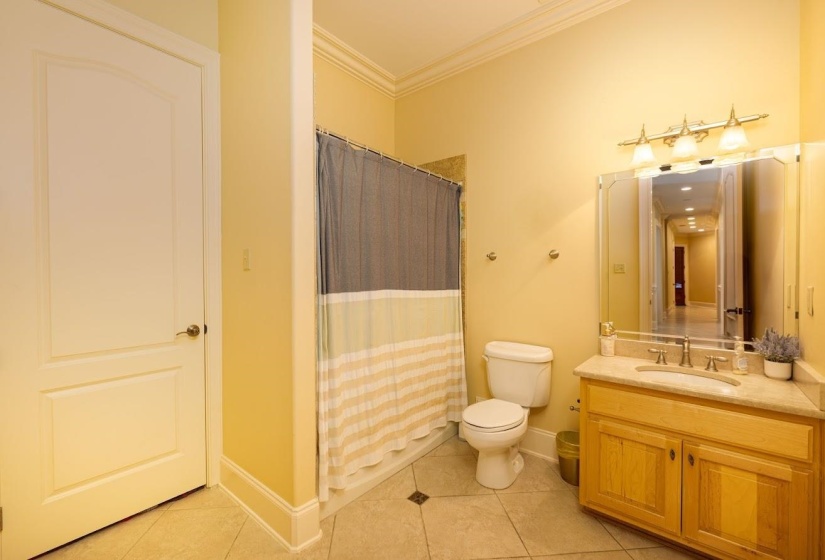 Bathroom featuring tile patterned floors, vanity, a shower with curtain, toilet, and ornamental molding