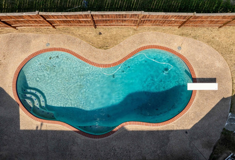 View of swimming pool featuring fence