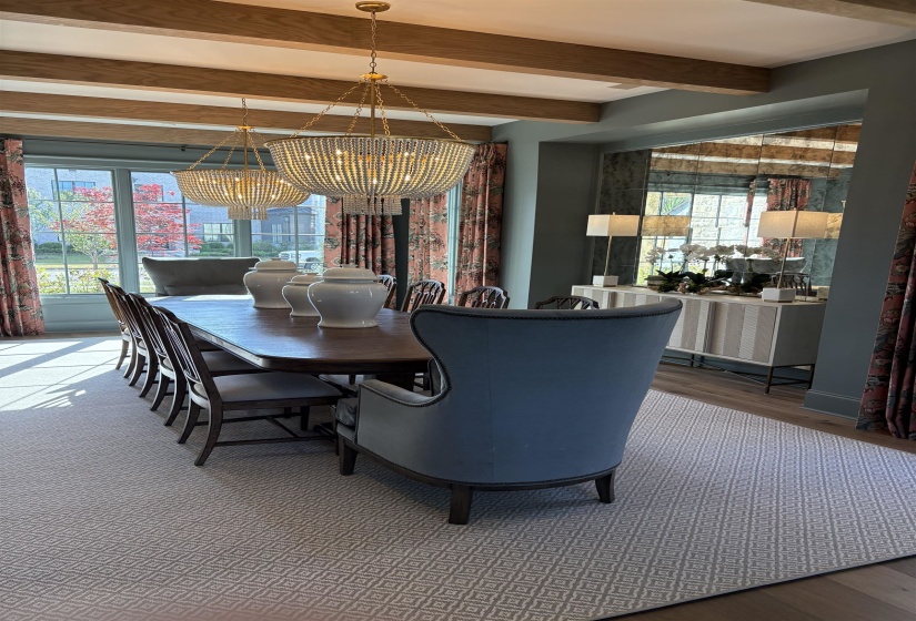 Dining area featuring beamed ceiling, wood finished floors, a chandelier, and a healthy amount of sunlight