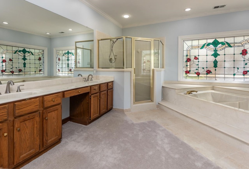 Full bathroom featuring crown molding, a sink, a stall shower, double vanity, and visible vents