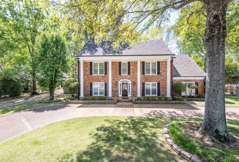 View of front of home featuring brick siding and a front lawn