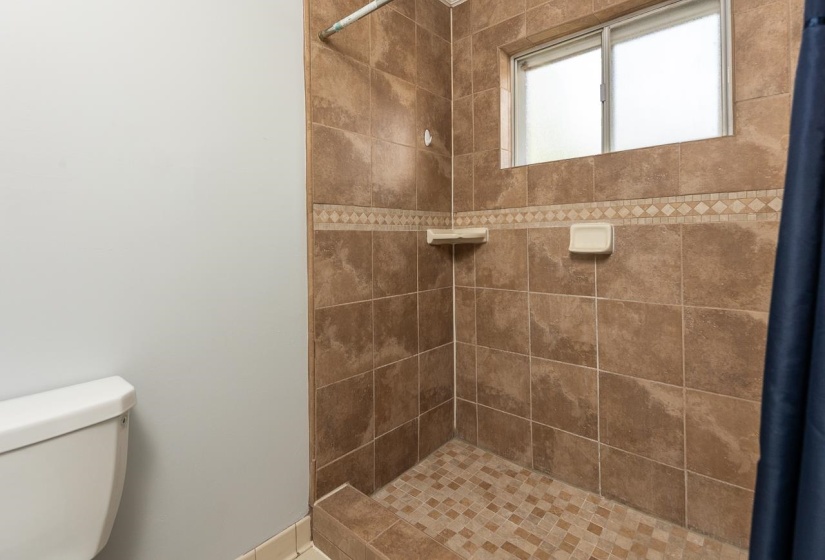 Full bathroom featuring a stall shower