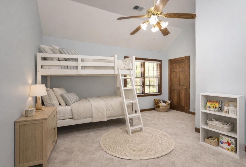 Bedroom with light carpet, lofted ceiling, and ceiling fan